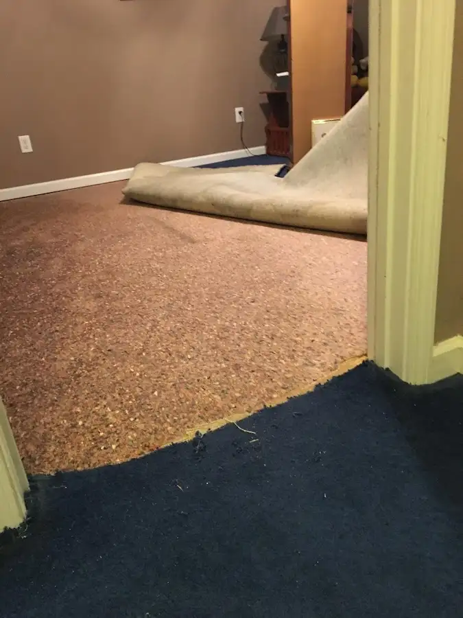 Carpet pad removal revealing water damage during Drying & Dehumidification in Groesbeck